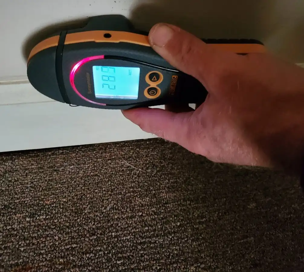 Moisture detection at baseboard during Storm Damage Restoration in Weiser